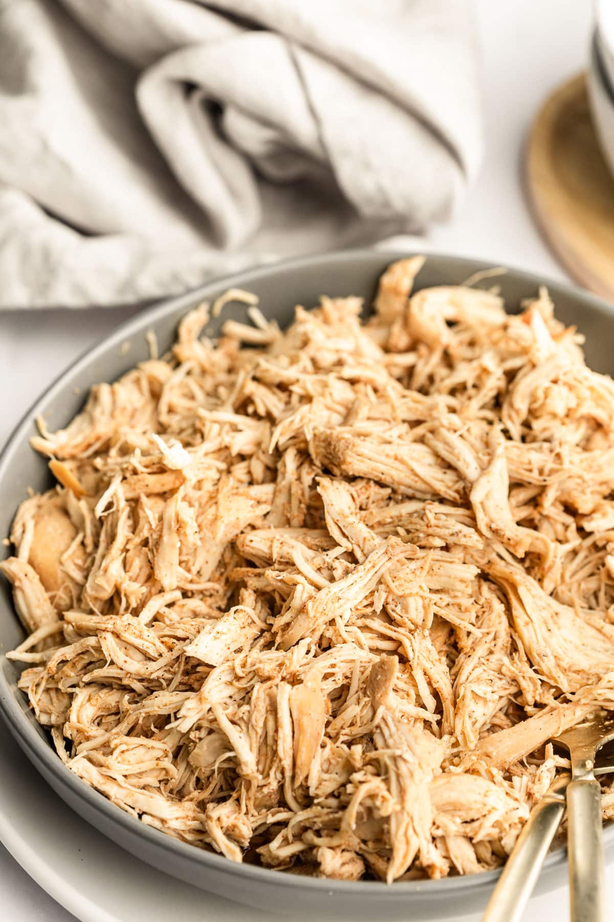 Cooked slow cooker shredded chicken in a bowl
